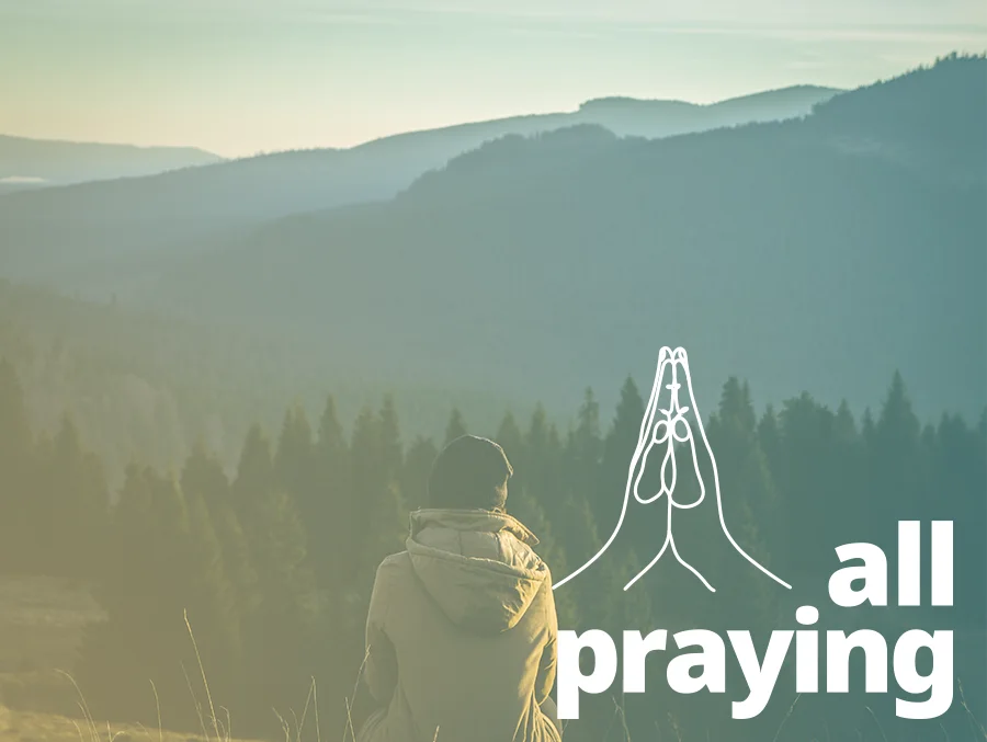 person sitting in solitude outside praying